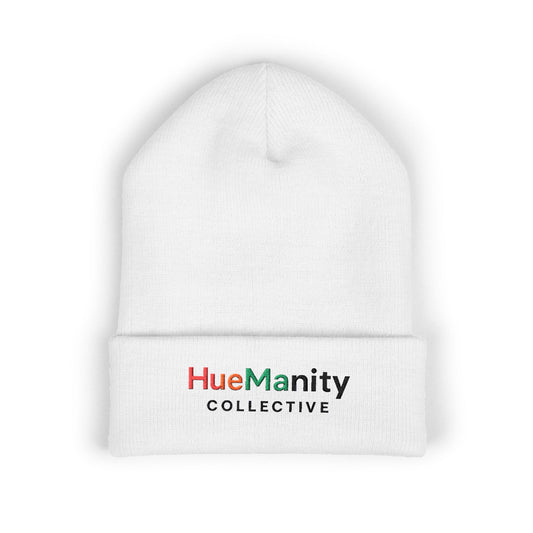 White beanie with 'HueManity Collective' logo on a white background